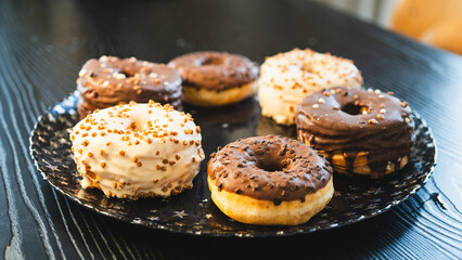 A vibrant selection of assorted donuts with various toppings and glazes, perfect for bakeries, cafés, or dessert promotions. Professional food photography with bright lighting