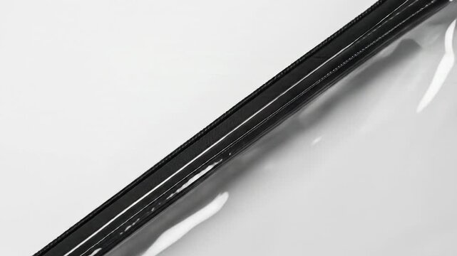 Black zipper on transparent surface minimalist design element with copy space