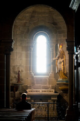 Priest praying in his church