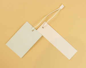 Two white empty labels on a beige background. Tags for prices or product names.