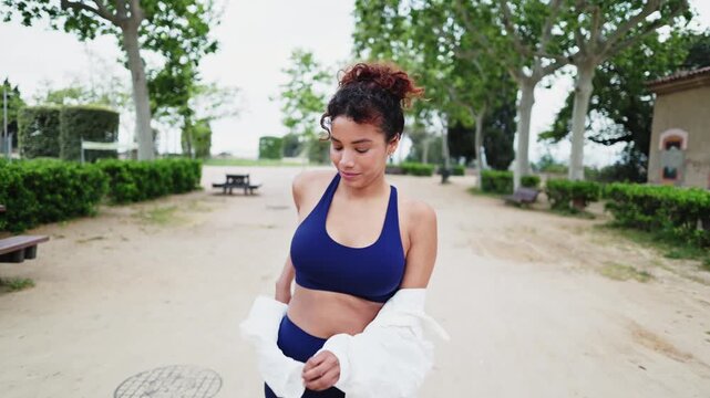 Young sporty woman taking off white shirt in slow motion