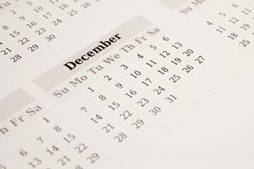 Closeup of December calendar page with dates
