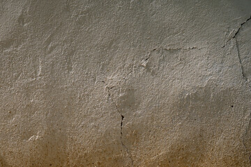 Cracked textured wall with sunlight and shadow

