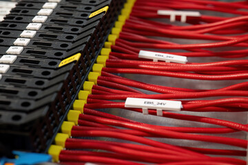 Closeup of red control panel wiring with connectors

