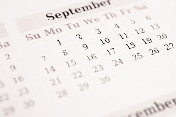 Closeup of September calendar page with dates
