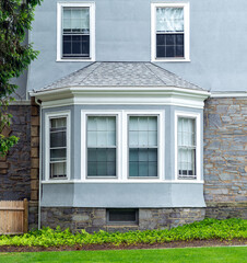Traditional home exterior with bay window and stone-stucco facade in Brookline, Massachusetts, USA