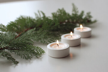 small serene icon set against backdrop of lush evergreen branches and soft flickering candles