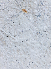 Rough textured white stone wall background with gray and blue specks