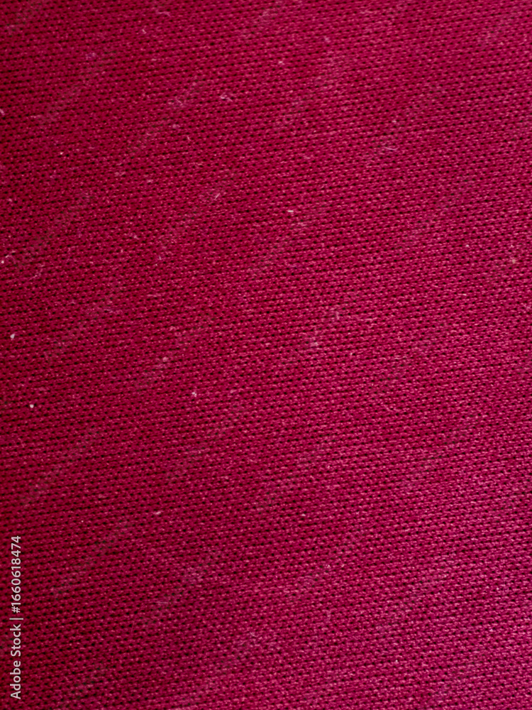 Poster close up of textured red fabric background with detailed weave pattern