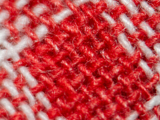 Red and white textile macro with woven yarn texture pattern