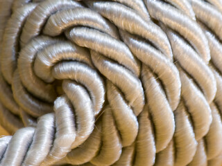 Close up of thick silver synthetic rope with smooth texture