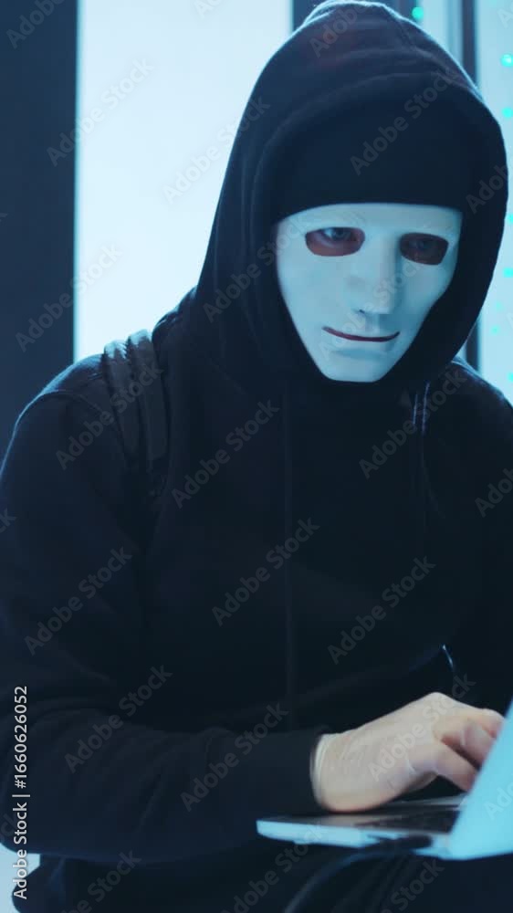 Aufkleber a mysterious hacker clad in a black hoodie is deeply engaged in using a laptop device