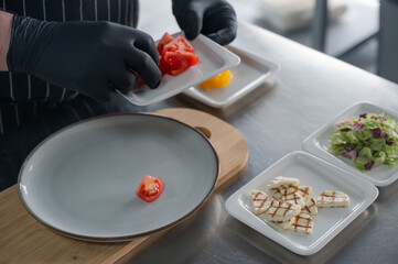 The chef lays out the salad. 