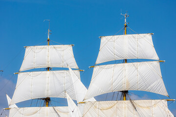 Ocean liner or Sea sailing ship concept, Selective focus of white boat canvas with rops on spar,...