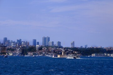 View of the Bosphorus. Maiden's Tower and the 15th of July Bridge. Tourism destination. Ships passing through the Bosphorus. Istanbul - Turkey.
