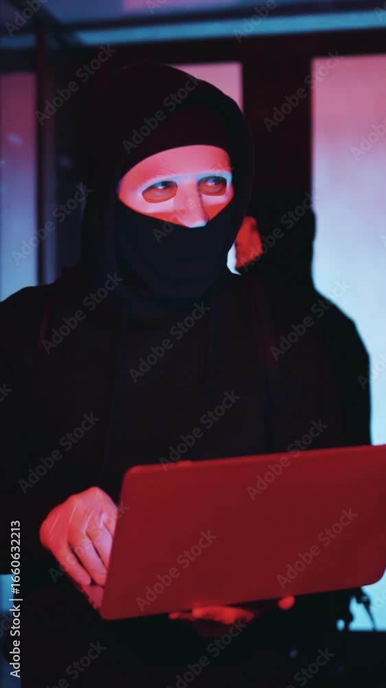 Poster a mysterious hacker works on a laptop in the dark, engaged with digital security threats