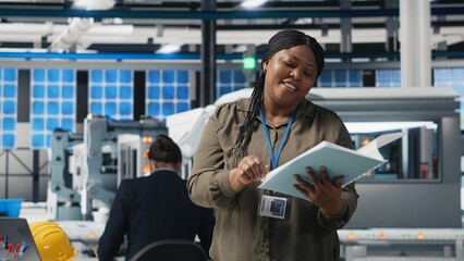 Professional female presenter discusses green energy business investment in a high tech solar panel plant, showcasing innovation for eco friendly sustainable solutions. Marketing ad. Camera B.