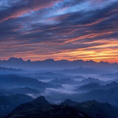 Fototapeta premium Sunrise over misty mountain ranges