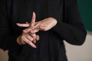 A woman shows the word integration in Russian sign language. 