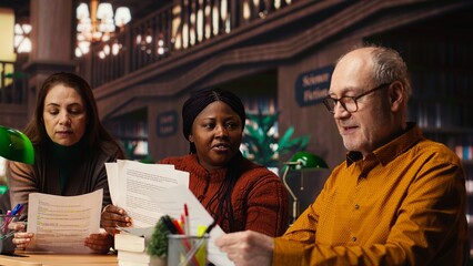 Cast members practicing script reading for a classic drama play in a library, showing dedication to acting and passion for character development. Theatrical arts role play.