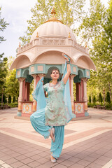 Woman Performing Traditional Dance in Ornate Pavilion