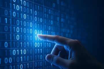 Human finger touching illuminated binary digits on futuristic blue digital screen symbolizing software development and coding