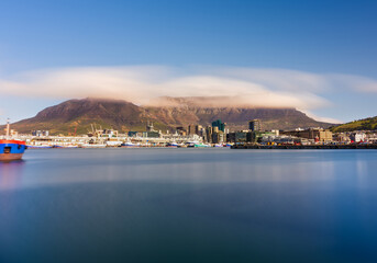 Fototapeta premium Wide angle long exposure of V and A Waterfront with clouded Table Mountain, Cape Town, South Africa
