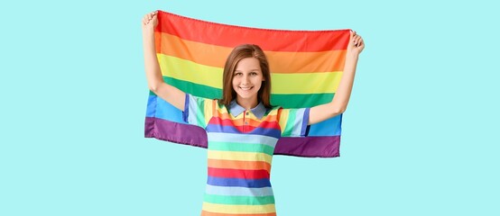 Young woman with LGBT flag on turquoise background
