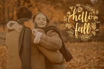 Happy couple with fallen leaf hugging in park. Hello Fall