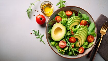 healthy vegetarian lunch of green salad with avocado tomatoes and a vibrant copy space image