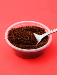 Portion of ground coffee in a spoon