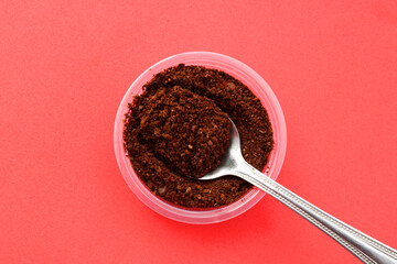 Spoon with a portion of ground coffee