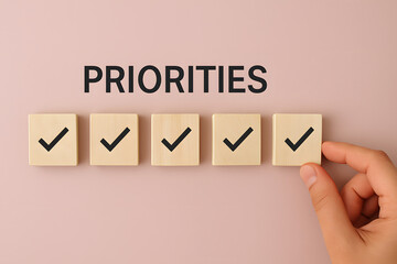 Priorities and Planning: A focused hand places the final checkmark on a list of wooden blocks, visually summarizing the essence of prioritizing tasks and meticulous planning