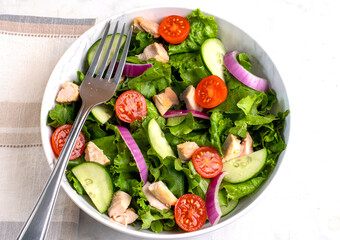 chicken salad with lettuce, tomatoes and  cucumbers