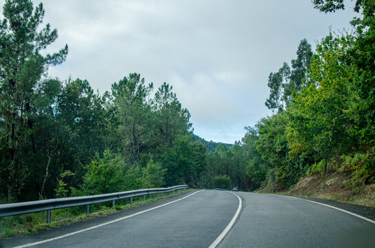 A Winding Mountain Road on a Cloudy Day. Concept A journey into the wilderness. - Powered by Adobe