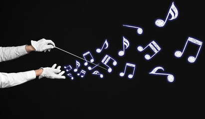 Hands of senior male conductor on dark background