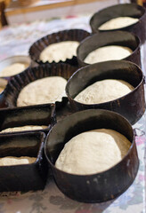 Traditional Easter bread dough in baking molds before oven