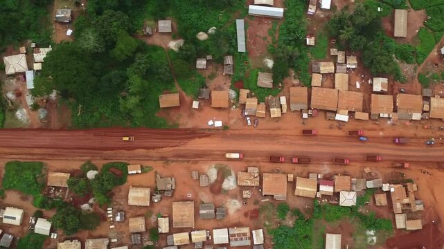 Striking Aerial View of Rural African Village with Red Clay Roads and Simple Buildings. Cameroon