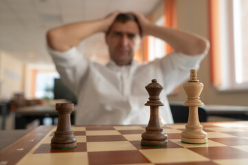 Middle aged Caucasian man playing chess. 