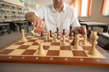 Middle aged Caucasian man playing chess. 