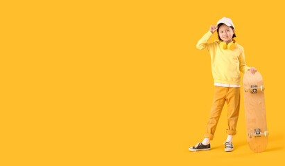 Stylish Asian girl with skateboard on yellow background with space for text © Pixel-Shot