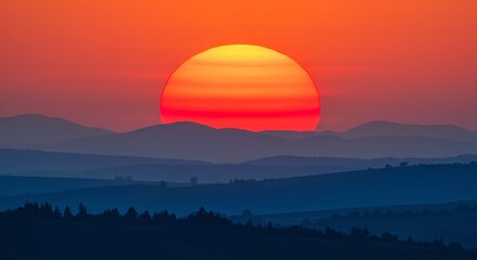 Sunset over mountains with hazy landscape