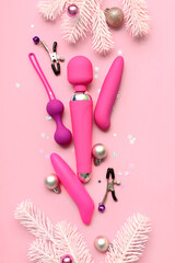 Sex toys and Christmas decor on pink background