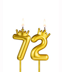 Golden number 72 birthday candle on white background