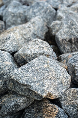 Detailed close-up of granite rocks stacked together, showing rough surface and natural stone texture.