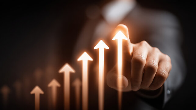 Business growth concept with hand pointing at upward trend represented by glowing arrows. image conveys motivation and success in achieving goals