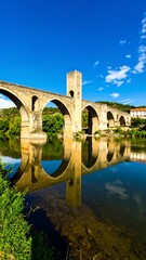 Fototapeta premium Stone bridge over calm river