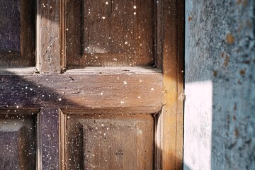Rustic Wooden Door Detail with Sunlight and Dust Motes Creating a Dreamy and Textured Effect
