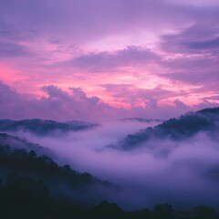 Fototapeta premium Misty mountaintops bathed in a vibrant, purple-pink sunrise