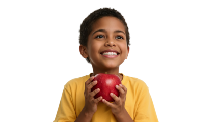 Young boy joyfully presenting a vibrant red apple against a black backdrop